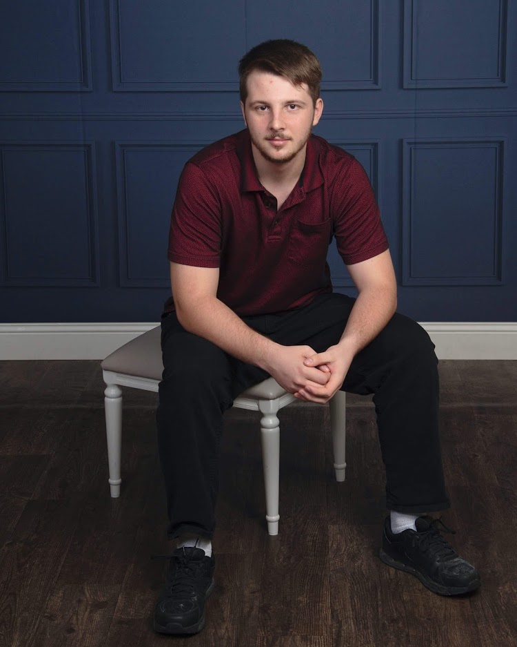 Photo of Austin Cuddeback sitting on a bench